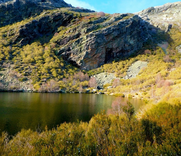 A lake in the mountains with a mountain in the background