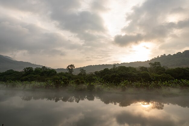 The lake reflects the countryside and the city