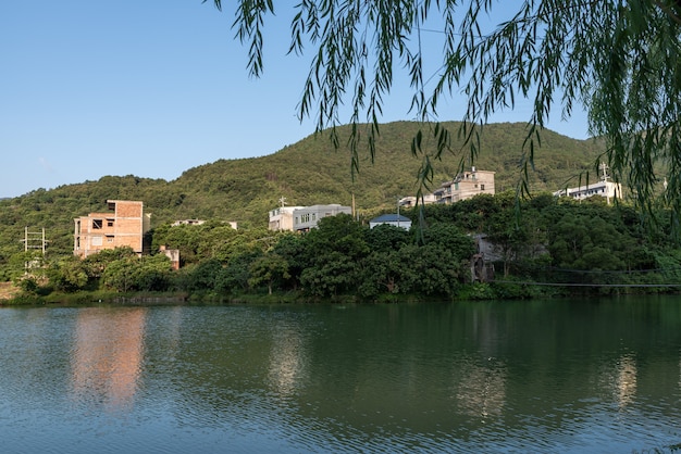 The lake reflects the mountains and villages