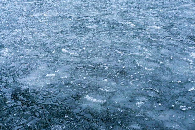 The lake surface with a pattern of broken ice