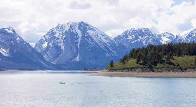 Lake surrounded by trees and mountains in american landscape