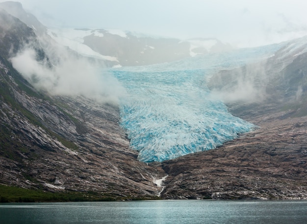 Lake Svartisvatnet and hazy cloudy view to Svartisen Glacier (Meloy, Norway)