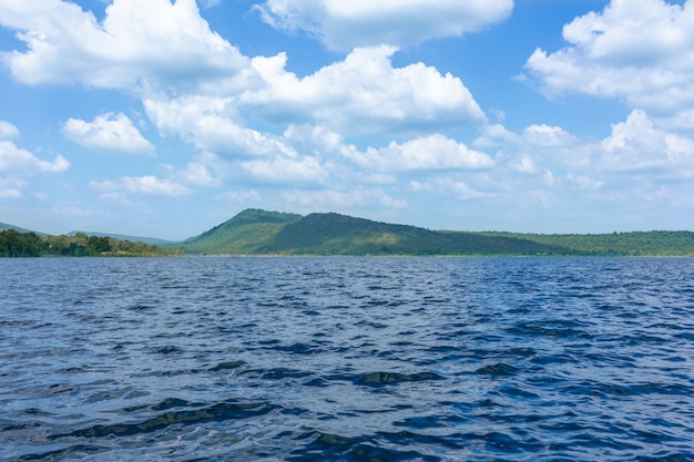 Lake swamp and green mountains, together with the blue sky and beautiful clouds