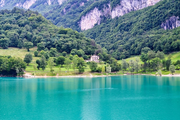 Lake Tenno a turquoise diamond in the green of the woods of a mountain lake in the area of the municipality of Tenno in Trentino, Italy