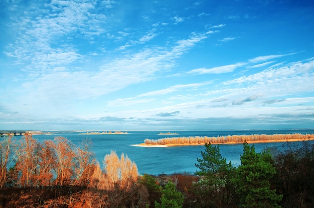 Lake trees blue sky with clouds