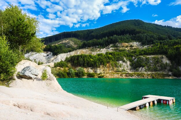 Lake with colorful green clean water in the summer in Carpathians mountains Sutovo Slovakia