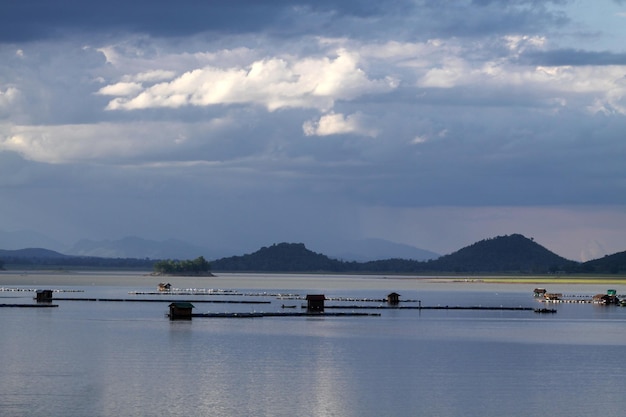 A lake with mountains in the background