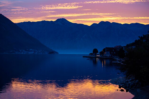 A lake with mountains in the background