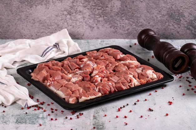 Lamb cubed meat Chopped red meat in a wooden serving dish on a stone background Butcher products