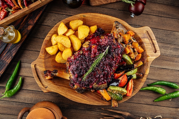 Lamb knuckle with lingonberry sauce and vegetables