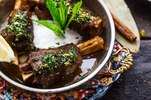 Lamb shanks in coper pan close view