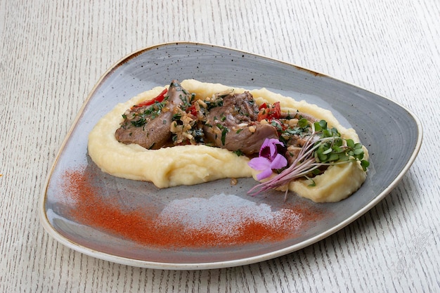 Lamb tongues with mashed potatoes stewed in a sauce with thyme and herbs