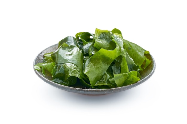 Laminaria or Kelp Seaweed in plate Isolated on White Background. fresh Laminaria or kelp Seaweed