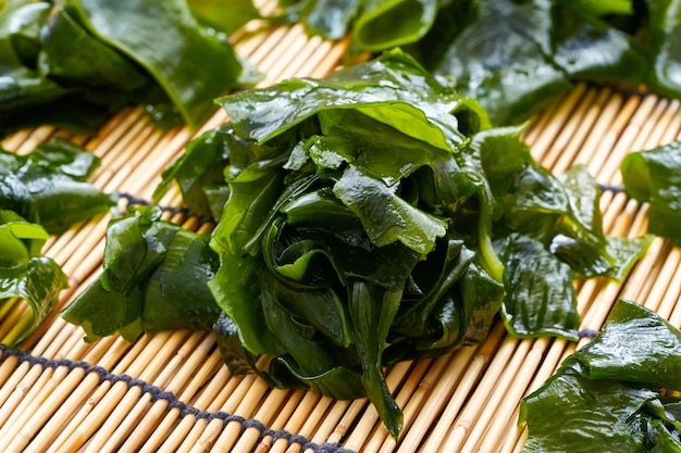 Laminaria or Kelp Seaweed on wood table Background. fresh Laminaria or kelp Seaweed Background.