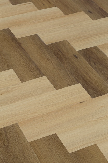Laminate and parquet with herringbone background wooden floor with a chevron pattern in the living r...