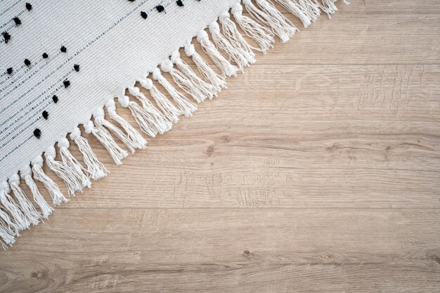 Laminate parquete floor. light wooden texture. white carpet.\
minimalism interior design concept