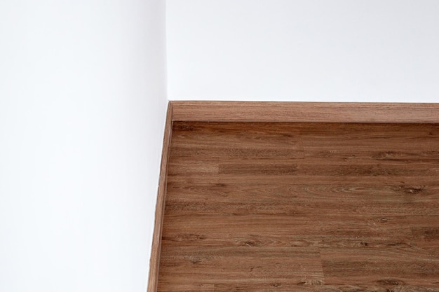 Laminate wood floor with blank white wall