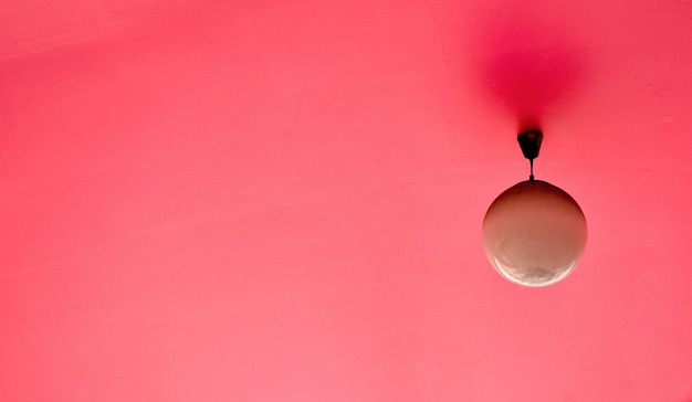 Lamp hanging from the pink ceiling