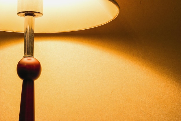 Lamp on a night table next to a bed