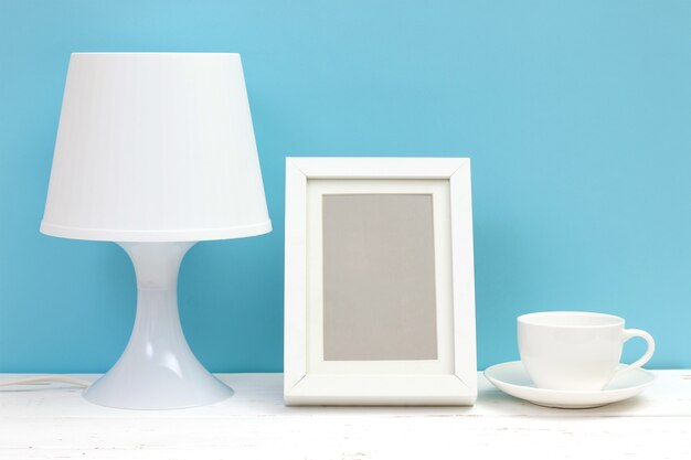 Lamp, photo frame and coffee cup on wooden table