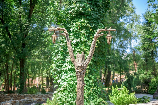 Lamp post made of wood in the form of a fairy-tale character