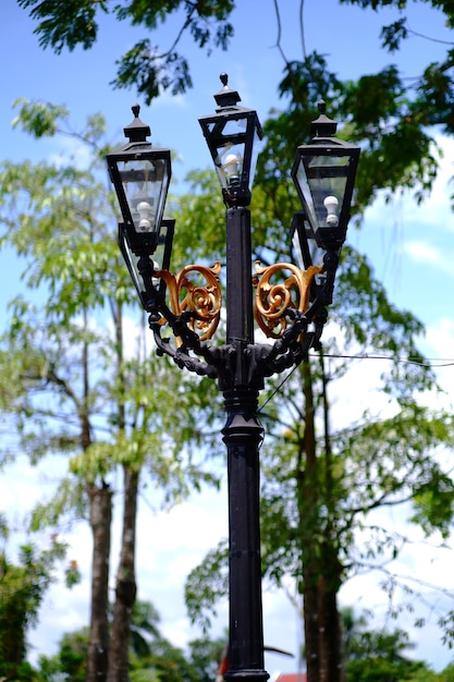 A lamp post with a gold design on it