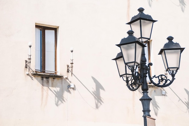 Photo a lamp post with a window that says quot the time of 11 00 quot