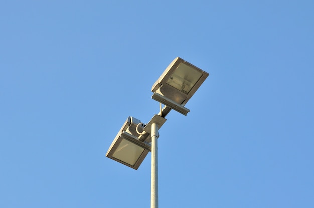 Lamp street lighting on the background of blue sky.