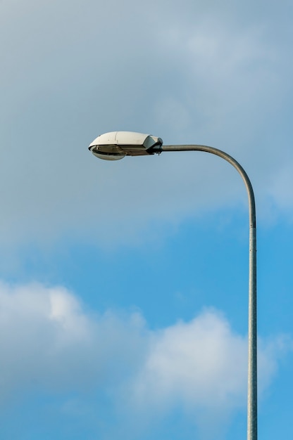 Lamp street lighting on the background of blue sky.