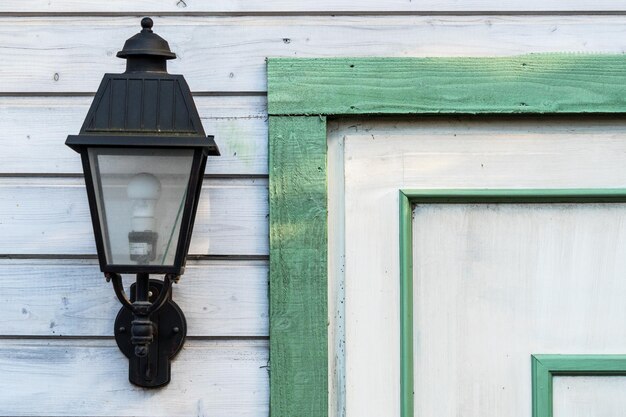 Lamp on wall by closed door