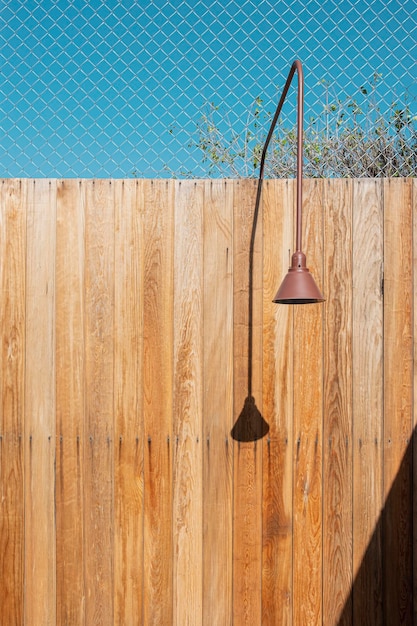 Lamp wooden fence and blue sky in alley urban scene