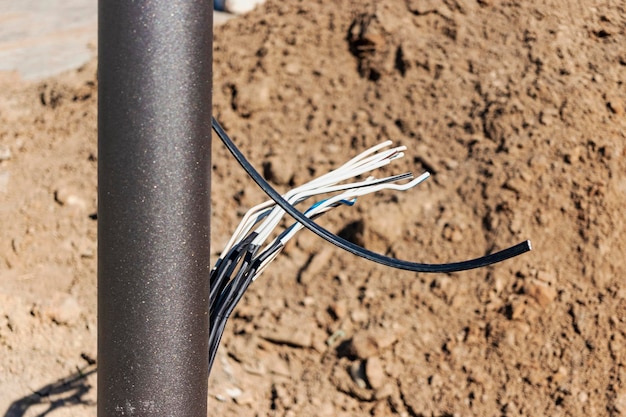 Lamppost with open hole inside is a power switch and electrical\
cables electrical connection for a lamppost installation of street\
lighting