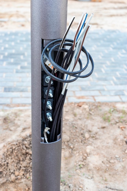 Lamppost with open hole inside is a power switch and electrical
cables electrical connection for a lamppost installation of street
lighting