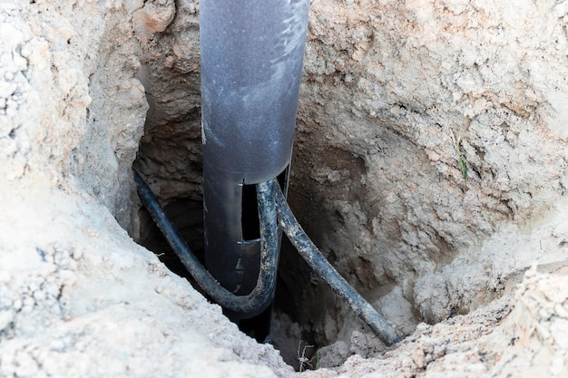 Lamppost with open hole Inside is a power switch and electrical cables Electrical connection for a lamppost Installation of street lighting