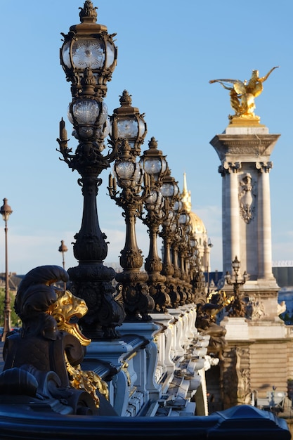 The lampposts of famous Alexandre III bridge Paris France