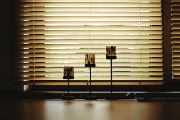 Photo lamps against blinds window at home