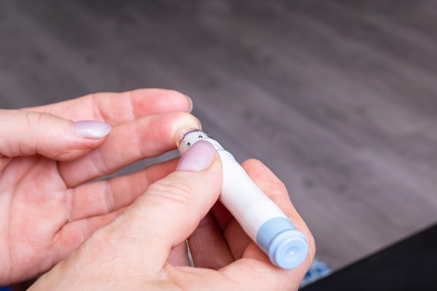 Lancet device in the hands of a woman