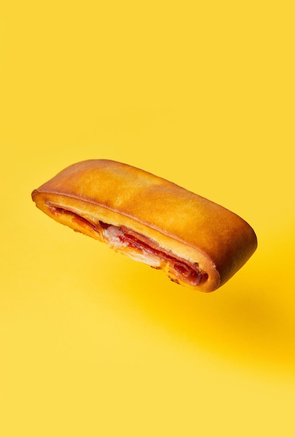 Lanche misto traditional portuguese sandwich with cheese and chorizo Tasty breakfast over yellow background