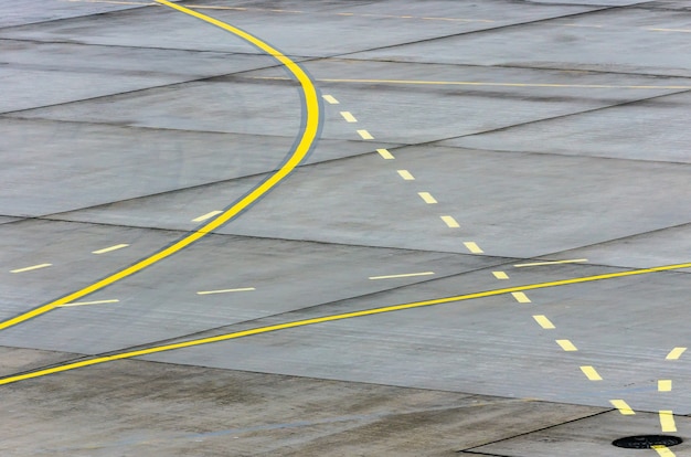 Landing light Directional sign markings on the tarmac of runway at a commercial airport.