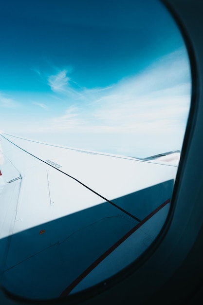 Landscape airplane flying view from inside window aircraft while traveling to Iceland and other countries Discover the world and adventure concepts Intercontinental international flight