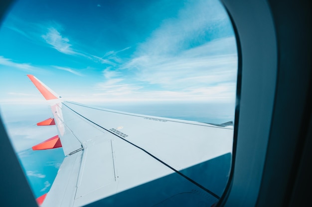 Landscape airplane flying view from inside window aircraftLow cost airlines and traveleasy to move to another countryDiscover the world and adventure conceptsIntercontinental international flight