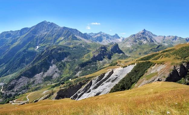 Landscape of alpine french mountain with a path from tour of Mont Blanc under blue sky