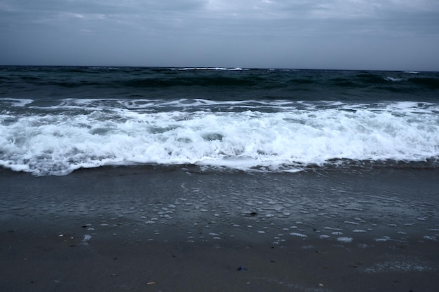 Landscape of blue ocean waves with beautiful clouds