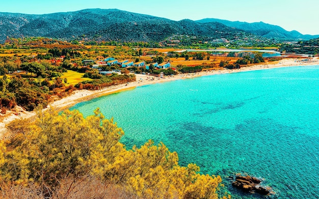 Landscape of chia beach and blue waters of the mediterranean sea in province of cagliari in south sardinia in italy. scenery and nature. mixed media