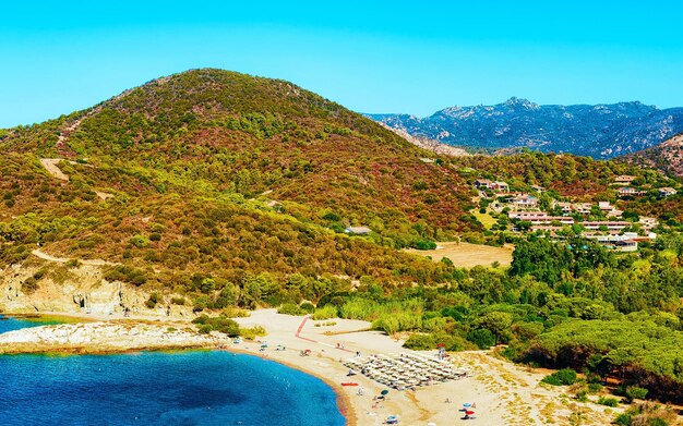 Landscape of Chia Beach and Blue Waters of the Mediterranean Sea in Province of Cagliari in South Sardinia in Italy. Scenery and nature. Mixed media.