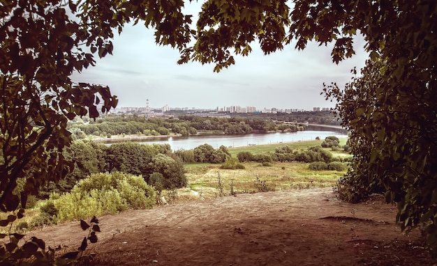 Landscape: the city near the forest and the river. clouds in the sky. ecologically alternative.