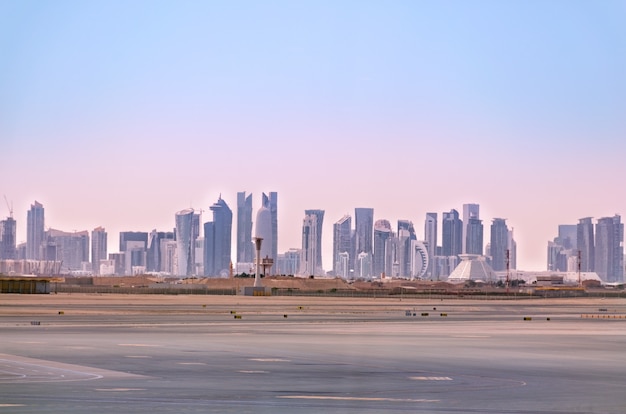 Landscape of city with modern buildings under pink sky