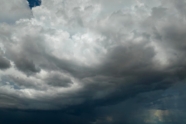 Landscape of dark ominous clouds forming on stormy sky during heavy thunderstorm