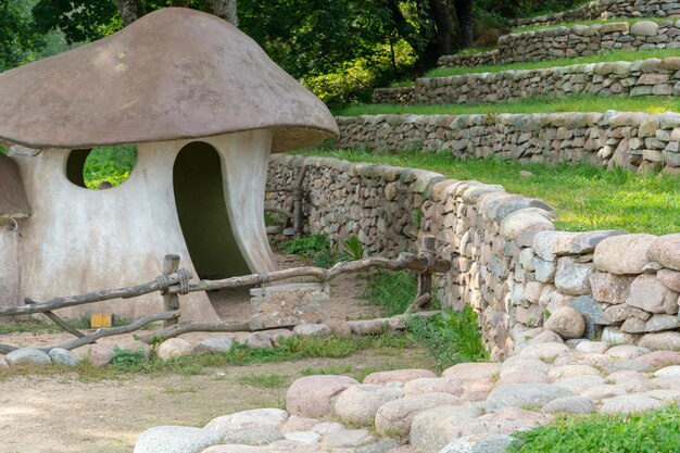 Landscape design Stepped terrace secured with raw stones Hobbit village Designer house in the form of a large mushroom