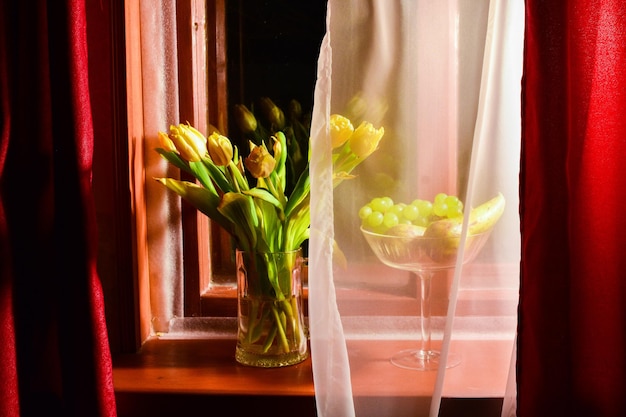 Landscape fliwers tulips on a windowsill